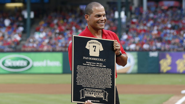 Jul 20, 2013; Arlington, TX, USA; Texas Rangers former catcher Ivan Rodriguez poses with his Rangers Hall of Fame plaque that was presented to him during an induction ceremony before the game against the Baltimore Orioles at the Rangers Ballpark. Photo Credit: Jim Cowsert-USA TODAY Sports