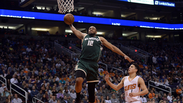 Feb 4, 2017; Phoenix, AZ, USA; Milwaukee Bucks forward Jabari Parker (12) goes up for a dunk over Phoenix Suns guard Devin Booker (1) during the first half at Talking Stick Resort Arena. Photo Credit: Joe Camporeale-USA TODAY Sports