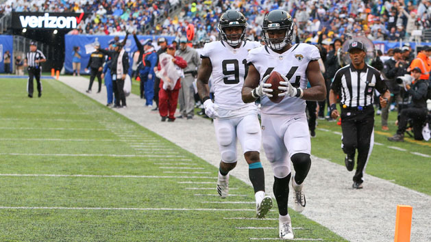 Sep 9, 2018; East Rutherford, NJ, USA; Jacksonville Jaguars linebacker Myles Jack (44) returns an interception for a touchdown in front of defensive end Yannick Ngakoue (91) during the second half at MetLife Stadium. Photo Credit: Vincent Carchietta-USA TODAY Sports