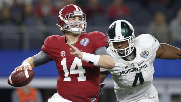 Dec 31, 2015; Arlington, TX, USA; Alabama Crimson Tide quarterback Jake Coker (14) is pressured by Michigan State Spartans defensive lineman Malik McDowell (4) in the third quarter in the 2015 CFP semifinal at the Cotton Bowl at AT&T Stadium. Mandatory Credit: Tim Heitman-USA TODAY Sports