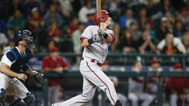 Jul 27, 2015; Seattle, WA, USA; Arizona Diamondbacks third baseman Jake Lamb (19) hits an RBI-sacrifice fly against the Seattle Mariners during the tenth inning at Safeco Field. Mandatory Credit: Joe Nicholson-USA TODAY Sports