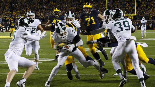 Oct 17, 2015; Ann Arbor, MI, USA; Michigan State Spartans defensive back Jalen Watts-Jackson (20) dives into the end zone for a game winning touchdown as the clock runs out in the fourth quarter against the Michigan Wolverines at Michigan Stadium. Michigan State 27-23. Mandatory Credit: Rick Osentoski-USA TODAY Sports