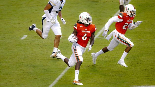 Nov 21, 2015; Miami Gardens, FL, USA; Miami Hurricanes defensive back Jamal Carter (6) carries the ball after making an interception against the Georgia Tech Yellow Jackets during the second half at Sun Life Stadium. Mandatory Credit: Steve Mitchell-USA TODAY Sports