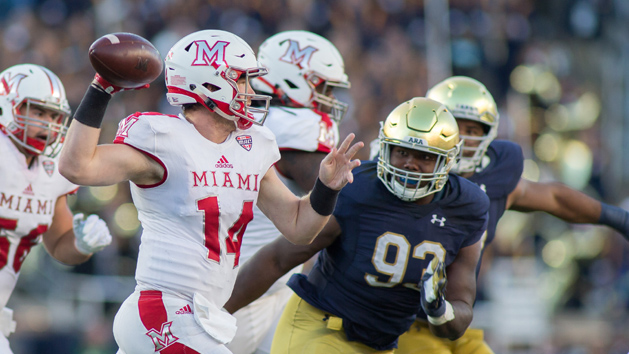 Sep 30, 2017; South Bend, IN, USA; Miami (Oh) Redhawks quarterback Gus Ragland (14) passes the ball as Notre Dame Fighting Irish defensive lineman Jay Hayes (93) defends in the first half at Notre Dame Stadium. Photo Credit: Trevor Ruszkowski-USA TODAY Sports