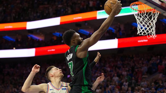 May 5, 2018; Philadelphia, PA, USA; Boston Celtics guard Jaylen Brown (7) scores past Philadelphia 76ers guard T.J. McConnell (12) with less then two seconds to go in the fourth quarter in game three of the second round of the 2018 NBA Playoffs at Wells Fargo Center. Photo Credit: Bill Streicher-USA TODAY Sports
