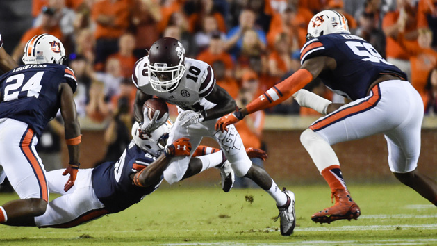 Sep 26, 2015; Auburn, AL, USA; Mississippi State Bulldogs running back Brandon Holloway (10) runs the ball while defended by Auburn Tigers defensive back Jeremiah Dinson (20) during the first quarter at Jordan Hare Stadium. Mandatory Credit: Shanna Lockwood-USA TODAY Sports