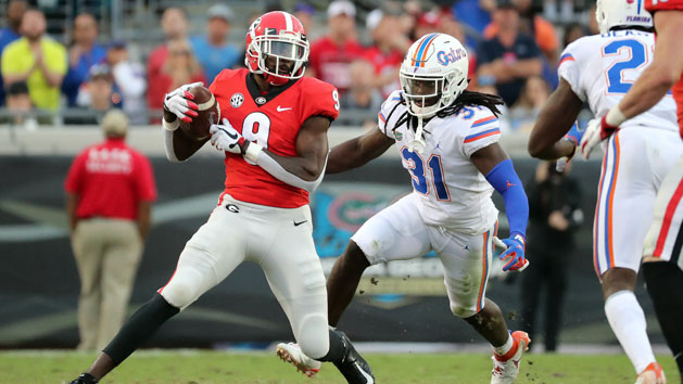 Oct 27, 2018; Jacksonville, FL, USA; Georgia Bulldogs wide receiver Jeremiah Holloman (9) catches the ball against Florida Gators defensive back Shawn Davis (31) during the second half at TIAA Bank Field. Photo Credit: Kim Klement-USA TODAY Sports