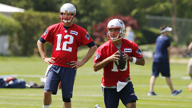 May 26, 2016; Foxborough, MA, USA; New England Patriots quarterback Tom Brady (12) looks on as quarterback Jimmy Garoppolo (10) looks to pass downfield during OTA's at Gillette Stadium. Photo Credit: Winslow Townson-USA TODAY Sports
