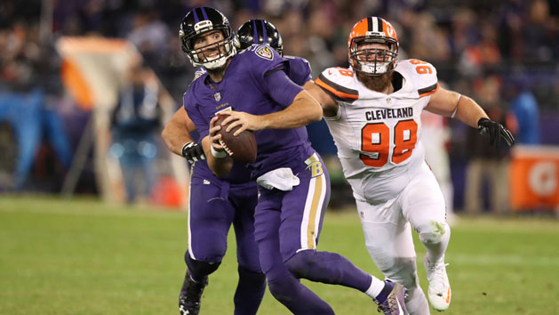 Nov 10, 2016; Baltimore, MD, USA; Baltimore Ravens quarterback Joe Flacco (5) runs from defensive pressure from Cleveland Browns defensive lineman Jamie Meder (98) at M&T Bank Stadium. Photo Credit: Mitch Stringer-USA TODAY Sports