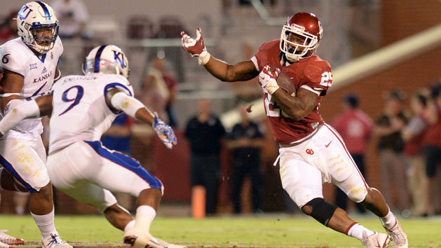 Oct 29, 2016; Norman, OK, USA; Kansas Jayhawks safety Fish Smithson (9) tackles Oklahoma Sooners running back Joe Mixon (25) during the second quarter at Gaylord Family - Oklahoma Memorial Stadium. Photo Credit: Mark D. Smith-USA TODAY Sports