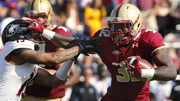 Sep 26, 2015; Boston, MA, USA; Boston College running back Jon Hilliman (32) stiff arms Northern Illinois cornerback Shawun Lurry (19) on his way to a touchdown during the second half of Boston College's 17-14 win over Northern Illinois at Alumni Stadium. Mandatory Credit: Winslow Townson-USA TODAY Sports