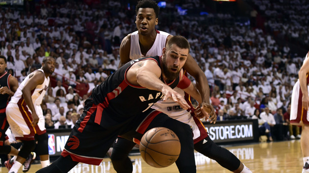May 7, 2016; Miami, FL, USA; Toronto Raptors center Jonas Valanciunas (17) and Miami Heat center Hassan Whiteside (21) both reach for a loose ball during the first quarter in game three of the second round of the NBA Playoffs at American Airlines Arena. Mandatory Credit: Steve Mitchell-USA TODAY Sports