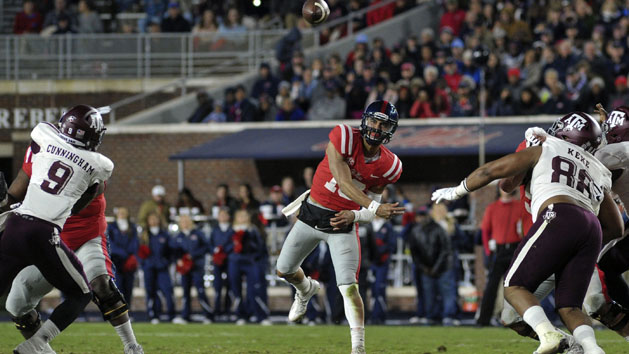 Nov 18, 2017; Oxford, MS, USA; Mississippi Rebels quarterback Jordan Ta'amu (10) passes the ball against Texas A&M Aggies defensive lineman Qualen Cunningham (9) during the first half at Vaught-Hemingway Stadium. Photo Credit: Justin Ford-USA TODAY Sports