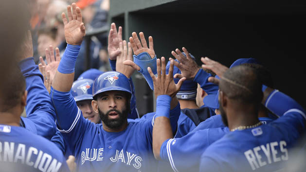 Apr 10, 2015; Baltimore, MD, USA; Toronto Blue Jays right fielder Jose Bautista (19) celebrates with teammates in the dugout after scoring in the first inning against the Baltimore Orioles at Oriole Park at Camden Yards. Photo Credit: Tommy Gilligan-USA TODAY Sports
