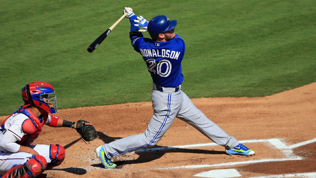 Oct 12, 2015; Arlington, TX, USA; Toronto Blue Jays third baseman Josh Donaldson (20) hits a home run against the Texas Rangers during the first inning in game four of the ALDS at Globe Life Park in Arlington. Mandatory Credit: Kevin Jairaj-USA TODAY Sports