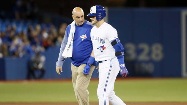 Apr 13, 2017; Toronto, Ontario, CAN; Toronto Blue Jays designated hitter Josh Donaldson (20) walks off the field with trainer George Poulis after hitting an rbi double in the sixth inning against the Baltimore Orioles at Rogers Centre. Photo Credit: John E. Sokolowski-USA TODAY Sports