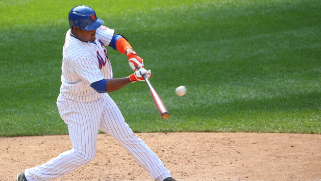 Jul 26, 2015; New York City, NY, USA; New York Mets third baseman Juan Uribe (2) hits a walk single to deep left center allowing right fielder Curtis Granderson (not pictured) to score during the tenth inning against the Los Angeles Dodgers at Citi Field. The Mets won 3-2 in ten innings. Mandatory Credit: Anthony Gruppuso-USA TODAY Sports