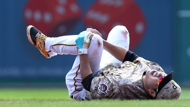 Sep 17, 2015; Pittsburgh, PA, USA; Pittsburgh Pirates shortstop Jung Ho Kang (27) grabs his leg after suffering an apparent injury against the Chicago Cubs during the first inning at PNC Park. Kang left the game. Mandatory Credit: Charles LeClaire-USA TODAY Sports