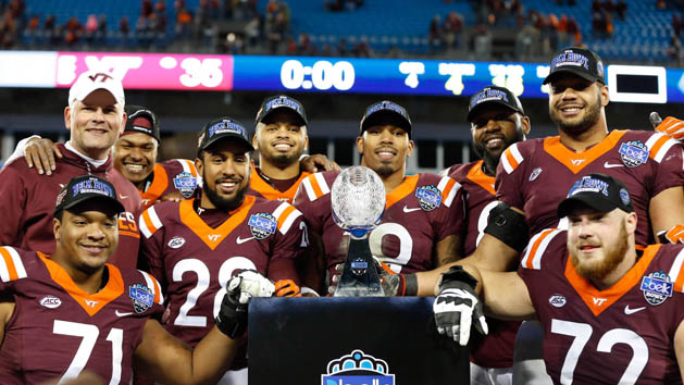 Dec 29, 2016; Charlotte, NC, USA; The Virginia Tech Hokies seniors pose for a picture with the trophy after defeating the Arkansas Razorbacks in the Belk Bowl at Bank of America Stadium. Virginia Tech defeated Arkansas 35-24. Photo Credit: Jeremy Brevard-USA TODAY Sports