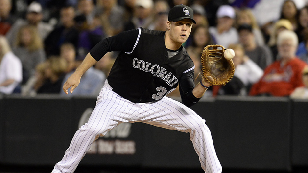 Sep 18, 2015; Denver, CO, USA; Colorado Rockies first baseman Justin Morneau (33) pulls in a catch for an out in the eighth inning against the San Diego Padres at Coors Field. Mandatory Credit: Ron Chenoy-USA TODAY Sports