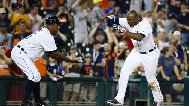 Jun 20, 2016; Detroit, MI, USA; Detroit Tigers left fielder Justin Upton (8) receives congratulations from third base coach Dave Clark (25) as he runs the bases after he hits a game winning home run in the 12th inning against the Seattle Mariners at Comerica Park. Detroit won 8-7 in twelve innings. Mandatory Credit: Rick Osentoski-USA TODAY Sports