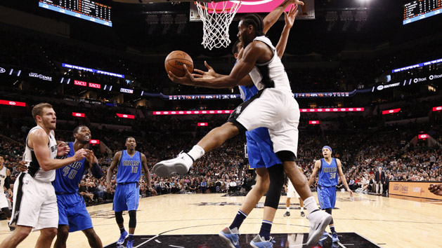 Nov 21, 2016; San Antonio, TX, USA; San Antonio Spurs small forward Kawhi Leonard (2, front) shoots around Dallas Mavericks center Salah Mejri (50, behind) during the second half at AT&T Center. Photo Credit: Soobum Im-USA TODAY Sports