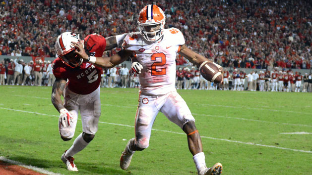Nov 4, 2017; Raleigh, NC, USA; Clemson Tigers quarterback Kelly Bryant (2) stiff arms North Carolina State Wolfpack cornerback Johnathan Alston (5) as he runs into the endzone during the second half at Carter-Finley Stadium. Clemson won 38-31. Photo Credit: Rob Kinnan-USA TODAY Sports