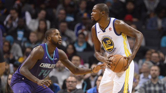 Dec 6, 2017; Charlotte, NC, USA; Golden State Warriors forward Kevin Durant (35) tries to pass against Charlotte Hornets forward Michael Kidd-Gilchrist (14) during the second half at the Spectrum Center. The Warriors won 101-87. Photo Credit: Sam Sharpe-USA TODAY Sports