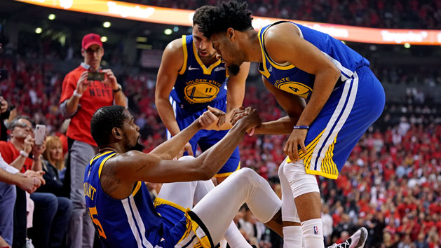 Jun 10, 2019; Toronto, Ontario, CAN; Golden State Warriors forward Kevin Durant (35) is helped up by guard Quinn Cook (4) and guard Klay Thompson (11) after an apparent injury during the second quarter in game five of the 2019 NBA Finals against the Toronto Raptors at Scotiabank Arena. Photo Credit: Kyle Terada-USA TODAY Sports
