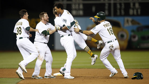 Jun 15, 2017; Oakland, CA, USA Oakland Athletics outfielder Khris Davis (2) is congratulated by teammates after hitting a two run single to win the game against the New York Yankees in the tenth inning at Oakland Coliseum. Photo Credit: Cary Edmondson-USA TODAY Sports