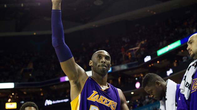 Dec 28, 2015; Charlotte, NC, USA; Los Angeles Lakers forward Kobe Bryant (24) waves to the fans after leaving the game late in the fourth quarter against the Charlotte Hornets at Time Warner Cable Arena. The Hornets won 108-98. Mandatory Credit: Jeremy Brevard-USA TODAY Sports