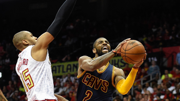 May 6, 2016; Atlanta, GA, USA; Cleveland Cavaliers guard Kyrie Irving (2) goes to the basket past Atlanta Hawks center Al Horford (15) during the second half in game three of the second round of the NBA Playoffs at Philips Arena. The Cavaliers defeated the Hawks 121-108. Mandatory Credit: Dale Zanine-USA TODAY Sports