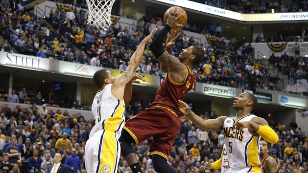 Feb 1, 2016; Indianapolis, IN, USA; Cleveland Cavaliers guard Kyrie Irving (2) shoots the ball in front of Indiana Pacers guard George Hill (3) at Bankers Life Fieldhouse. The Cavaliers won 111-106 in overtime. Mandatory Credit: Brian Spurlock-USA TODAY Sports