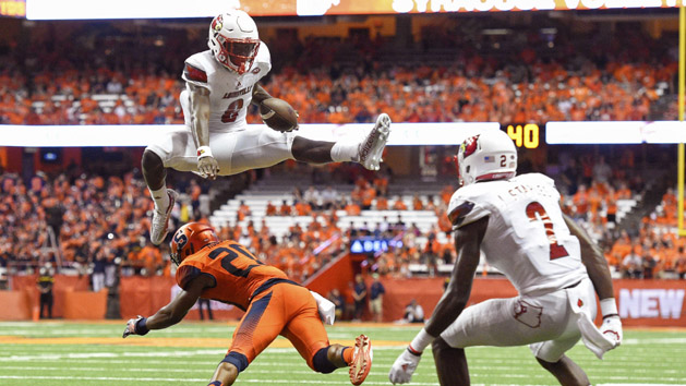 Sep 9, 2016; Syracuse, NY, USA; Louisville Cardinals quarterback Lamar Jackson (8) leaps over Syracuse Orange defensive back Cordell Hudson (20) during the second quarter at the Carrier Dome. Photo Credit: Rich Barnes-USA TODAY Sports