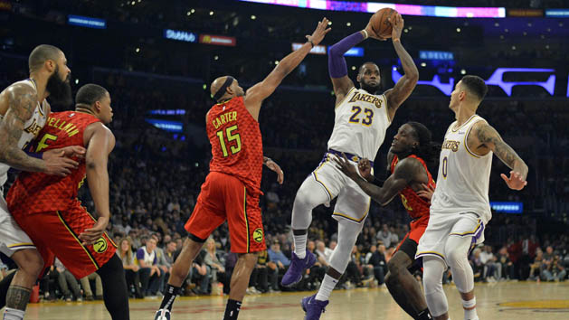 Nov 11, 2018; Los Angeles, CA, USA; Los Angeles Lakers forward LeBron James (23) is guarded by Atlanta Hawks forward Vince Carter (15) and forward Taurean Prince (12) during the second half at Staples Center. Photo Credit: Jake Roth-USA TODAY Sports