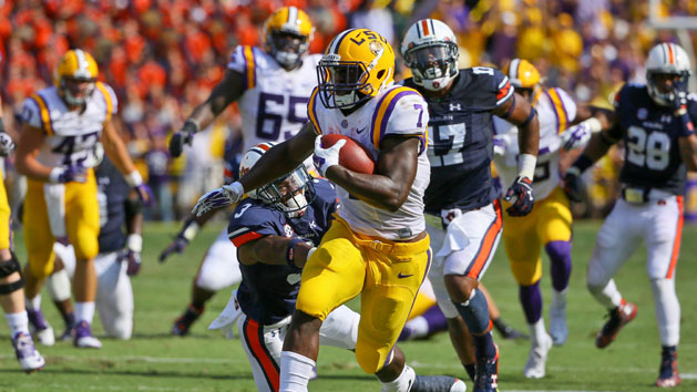 Sep 19, 2015; Baton Rouge, LA, USA; LSU Tigers running back Leonard Fournette (7) breaks a tackle by Auburn Tigers defensive back Jonathan Jones (3) during the second quarter of a game at Tiger Stadium. Mandatory Credit: Derick E. Hingle-USA TODAY Sports