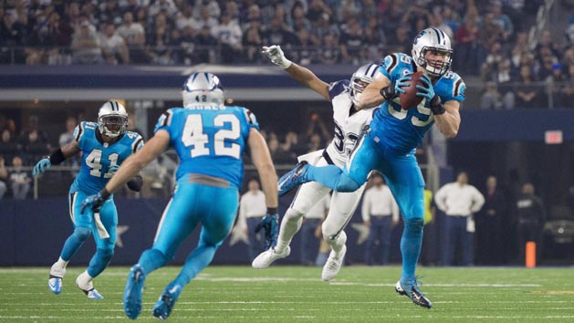 Nov 26, 2015; Arlington, TX, USA; Carolina Panthers middle linebacker Luke Kuechly (59) intercepts a pass thrown by Dallas Cowboys quarterback Tony Romo (not pictured) and scores a touchdown during the second quarter of an NFL game on Thanksgiving at AT&T Stadium. Mandatory Credit: Jerome Miron-USA TODAY Sports