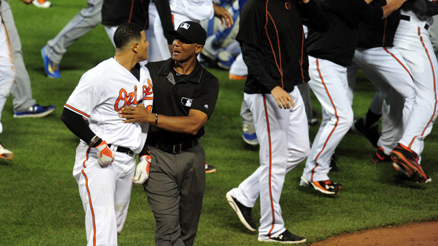 Jun 7, 2016; Baltimore, MD, USA; Baltimore Orioles shortstop Manny Machado (13) is restrained by first base umpire C.B. Bucknor (center) during a brawl in the fifth inning against the Kansas City Royals at Oriole Park at Camden Yards. The Orioles won 9-1. Photo Credit: Evan Habeeb-USA TODAY Sports