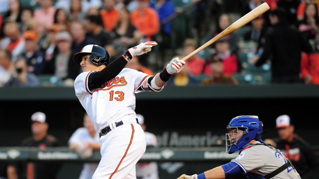 Apr 20, 2016; Baltimore, MD, USA; Baltimore Orioles third baseman Manny Machado (13) hits an RBI double in the first inning against the Toronto Blue Jays at Oriole Park at Camden Yards. Mandatory Credit: Evan Habeeb-USA TODAY Sports