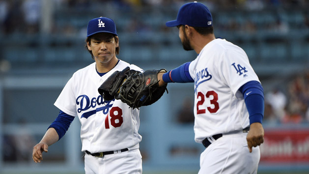 Apr 17, 2016; Los Angeles, CA, USA; Los Angeles Dodgers starting pitcher Kenta Maeda (18) celebrates with first baseman Adrian Gonzalez (23) during the seventh inning against the San Francisco Giants at Dodger Stadium. Mandatory Credit: Kelvin Kuo-USA TODAY Sports