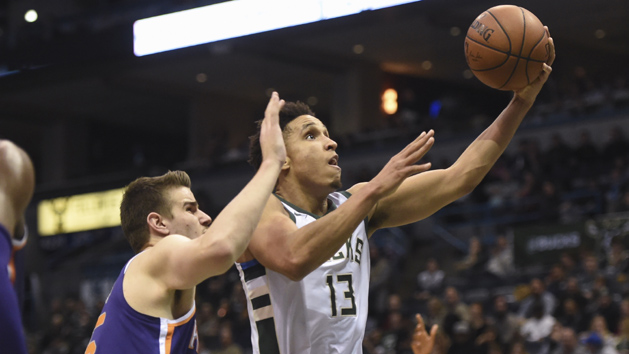 Jan 22, 2018; Milwaukee, WI, USA; Milwaukee Bucks guard Malcolm Brogdon (13) takes a shot ahead of Phoenix Suns forward Dragan Bender (35) in the third quarter at BMO Harris Bradley Center. Photo Credit: Benny Sieu-USA TODAY Sports