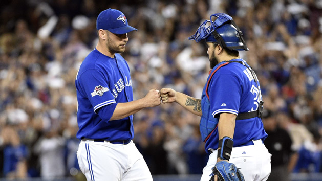 Oct 21, 2015; Toronto, Ontario, CAN; Toronto Blue Jays starting pitcher Marco Estrada (25) reacts with catcher Dioner Navarro (30) during the eighth inningin game five of the ALCS at Rogers Centre. Mandatory Credit: Nick Turchiaro-USA TODAY Sports
