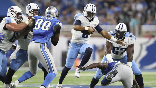 Sep 18, 2016; Detroit, MI, USA; Tennessee Titans quarterback Marcus Mariota (8) tries to hurdle Detroit Lions defensive end Wallace Gilberry (95) during the first quarter at Ford Field. Photo Credit: Raj Mehta-USA TODAY Sports