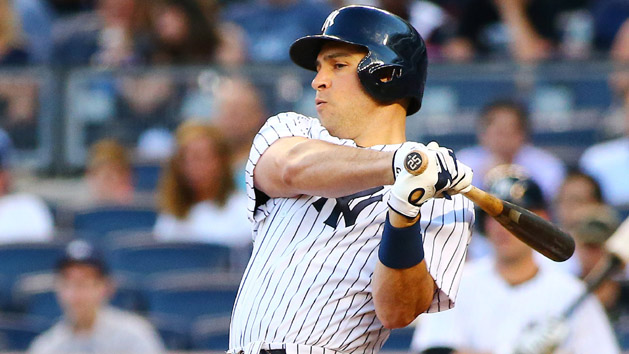 Aug 4, 2015; Bronx, NY, USA; New York Yankees first baseman Mark Teixeira (25) hits an RBI single in the first inning against the Boston Red Sox at Yankee Stadium. (Andy Marlin-USA TODAY Sports)