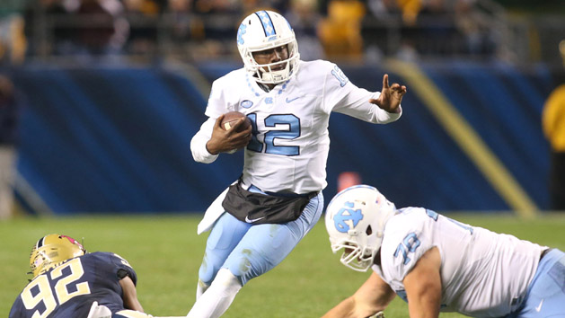 Oct 29, 2015; Pittsburgh, PA, USA; North Carolina Tar Heels quarterback Marquise Williams (12) scrambles with the ball against the Pittsburgh Panthers during the third quarter at Heinz Field. The Tar Heels won 26-19. Mandatory Credit: Charles LeClaire-USA TODAY Sports
