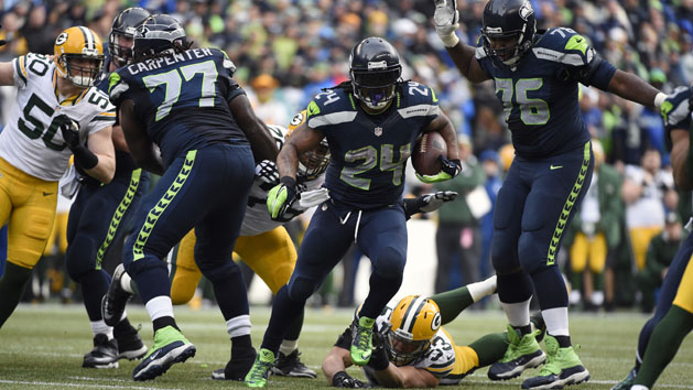January 18, 2015; Seattle, WA, USA; Seattle Seahawks running back Marshawn Lynch (24) runs the ball ahead of Green Bay Packers outside linebacker Nick Perry (53) during the second half in the NFC Championship game at CenturyLink Field. Photo Credit: Kyle Terada-USA TODAY Sports