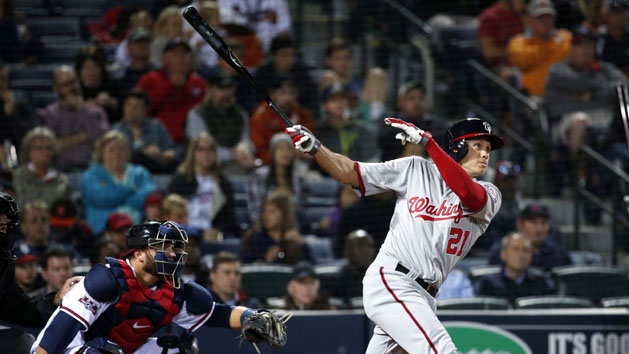 Apr 6, 2016; Atlanta, GA, USA; Washington Nationals left fielder Matt den Dekker (21) hits a two RBI double as Atlanta Braves catcher A.J. Pierzynski (15) is shown on the play in the seventh inning of their game at Turner Field. Mandatory Credit: Jason Getz-USA TODAY Sports