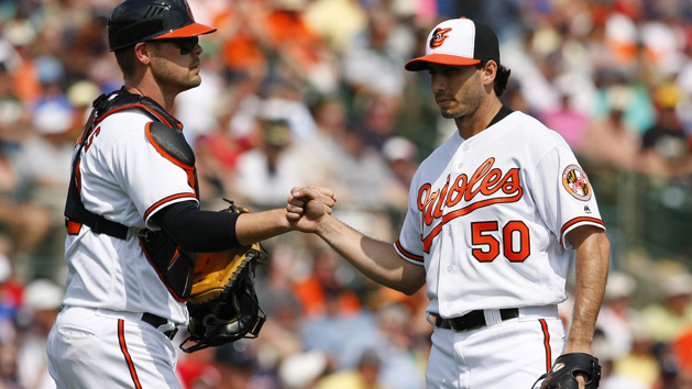 Mar 8, 2016; Sarasota, FL, USA; Baltimore Orioles starting pitcher Miguel Gonzalez (50) fist pumps with catcher Matt Wieters (32) as he is taken out of the game during the third inning against the Boston Red Sox at Ed Smith Stadium. Mandatory Credit: Kim Klement-USA TODAY Sports