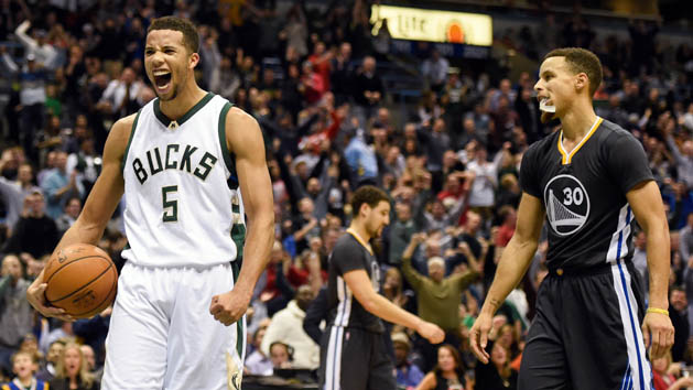 Dec 12, 2015; Milwaukee, WI, USA; Milwaukee Bucks guard Michael Carter-Williams (5) reacts in front of Golden State Warriors guard Stephen Curry (30) after a Bucks basket late in the fourth quarter at BMO Harris Bradley Center. The Bucks beat the Warriors 108-95. Mandatory Credit: Benny Sieu-USA TODAY Sports