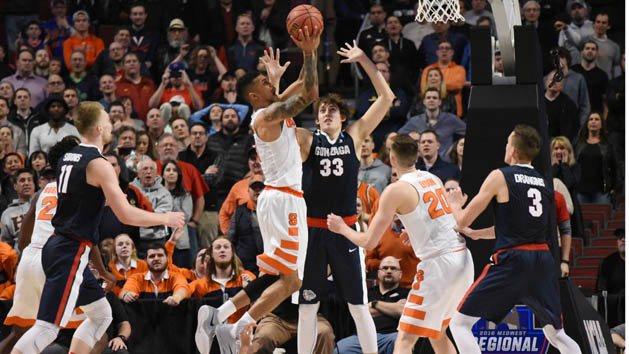 Mar 25, 2016; Chicago, IL, USA; Syracuse Orange forward Michael Gbinije (0) scores the go-ahead basket against Gonzaga Bulldogs forward Kyle Wiltjer (33) during the second half in a semifinal game in the Midwest regional of the NCAA Tournament at United Center. Mandatory Credit: David Banks-USA TODAY Sports